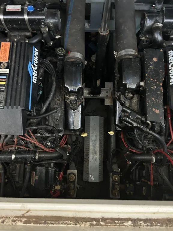Slide: The Image of 1997 Sea Ray 330 Sundancer engine compartment with MerCruiser engines. - 49