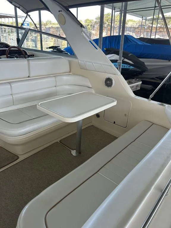 Slide: The Image of 1997 Sea Ray 330 Sundancer interior with white seating and table. - 9