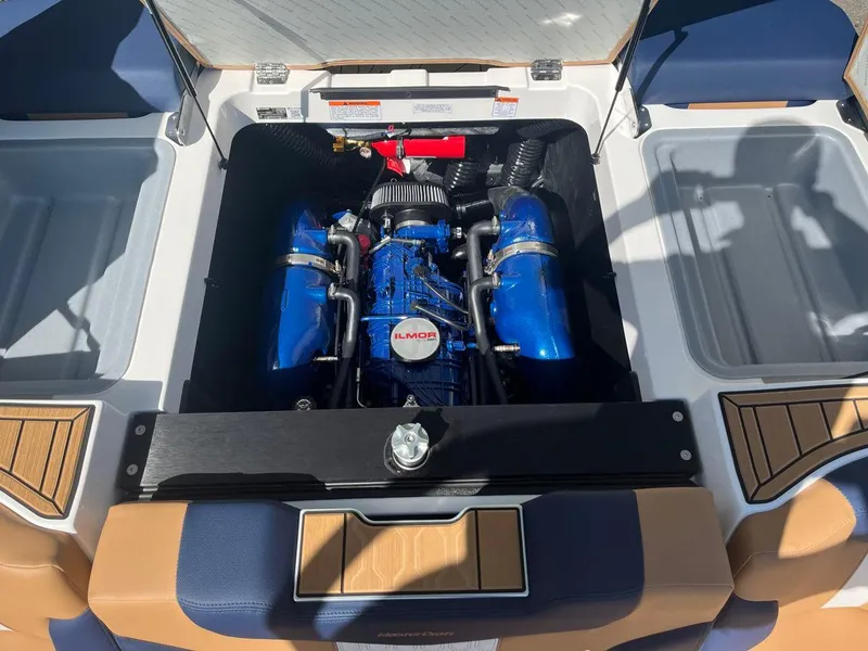 Slide: The Image of 2023 MasterCraft XT24 boat engine compartment with Ilmor engine. - 2