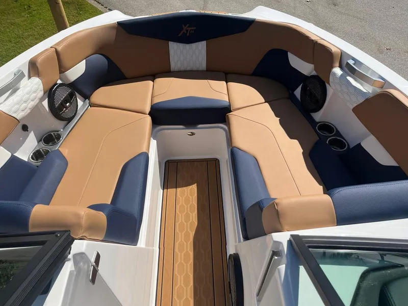 Slide: The Image of 2023 MasterCraft XT24 boat interior with tan and navy seating. - 3