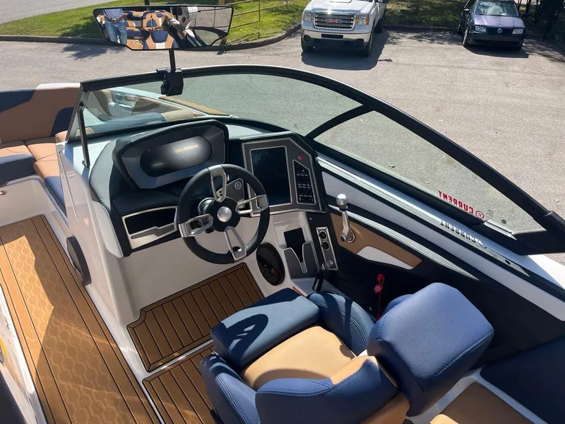 Slide: The Image of 2023 MasterCraft XT24 boat interior with modern dashboard and steering wheel. - 5