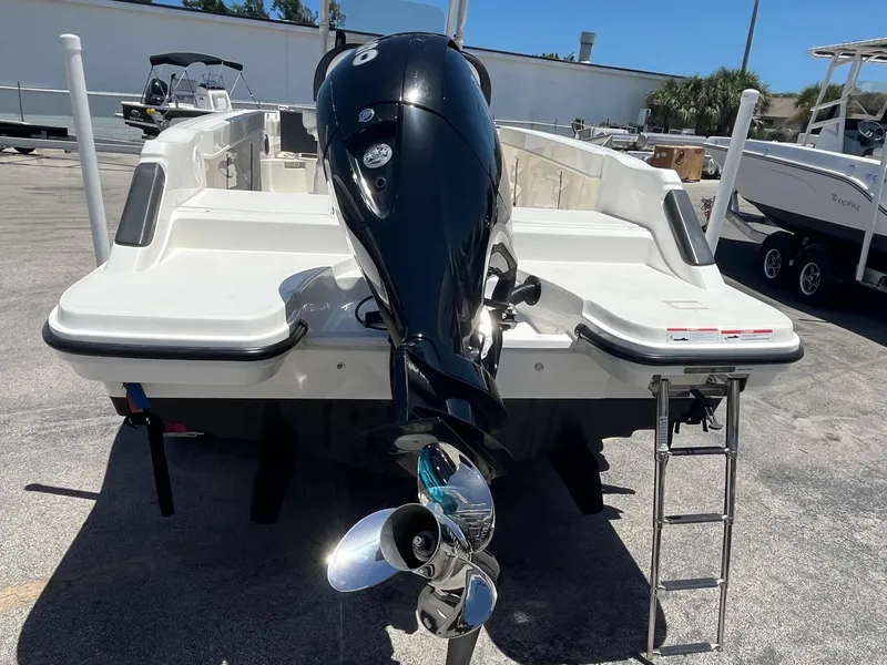 Slide: The Image of 2022 Bayliner Trophy T22CC boat with outboard motor and ladder. - 2