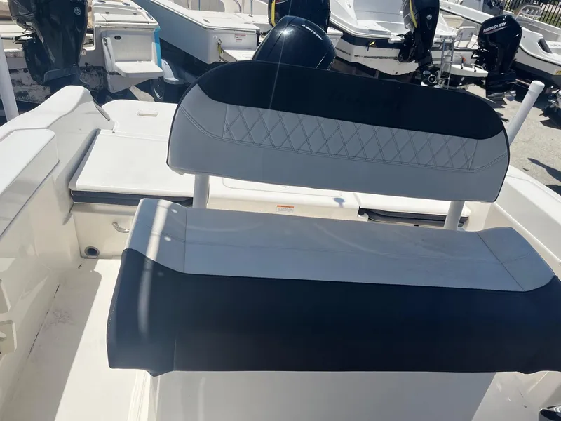 Slide: The Image of 2022 Bayliner Trophy T22CC boat seating area with black and white upholstery. - 3
