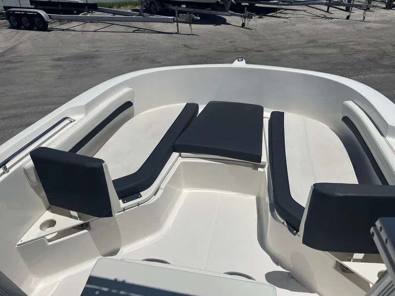 Slide: The Image of 2022 Bayliner Trophy T22CC boat with cushioned seating in the bow area. - 5