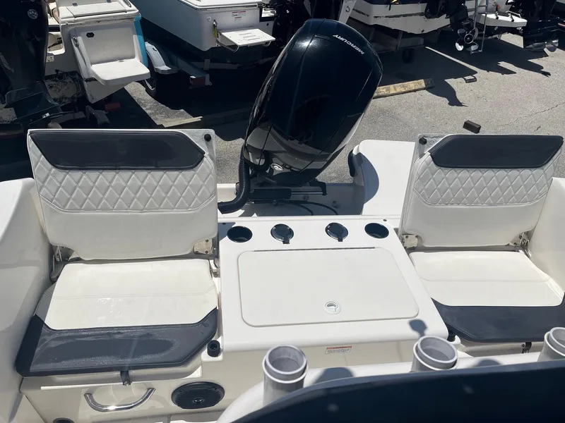 Slide: The Image of 2022 Bayliner Trophy T22CC boat interior with dual seats and outboard motor. - 7