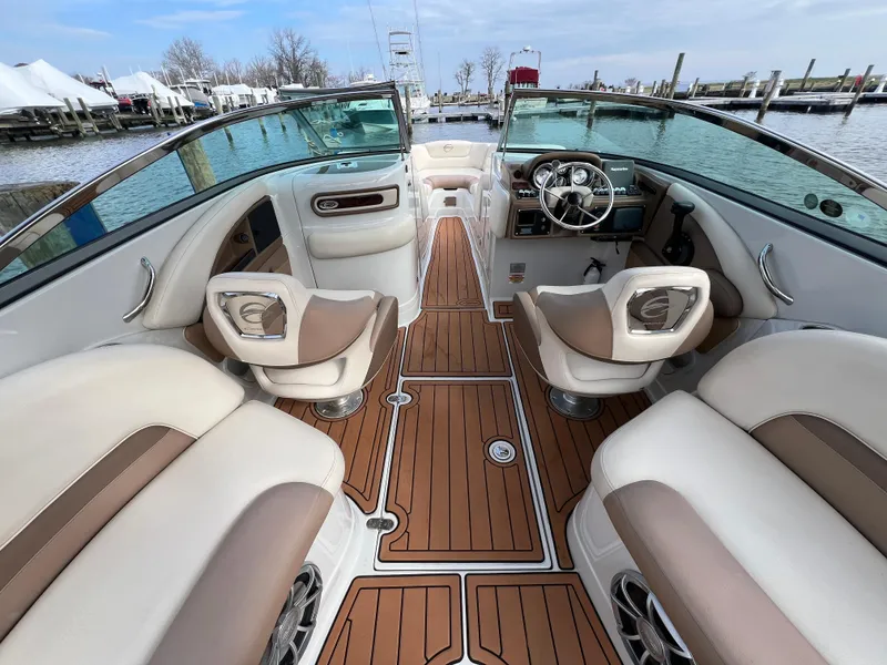 Slide: The Image of 2016 Crownline 270 SS boat interior with luxurious seating and wood-style flooring. - 10