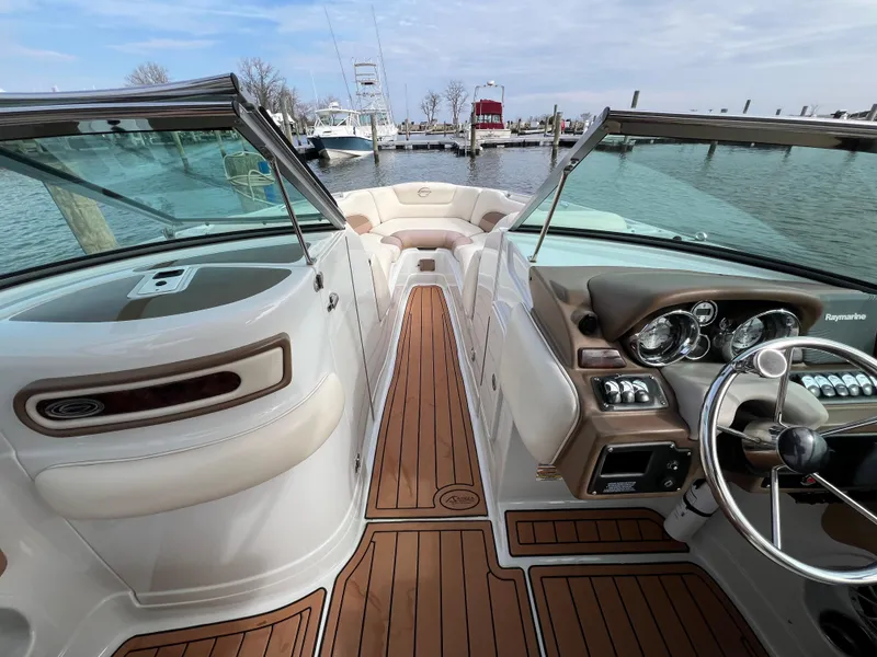 Slide: The Image of 2016 Crownline 270 SS boat interior with wood finish and modern dashboard. - 13