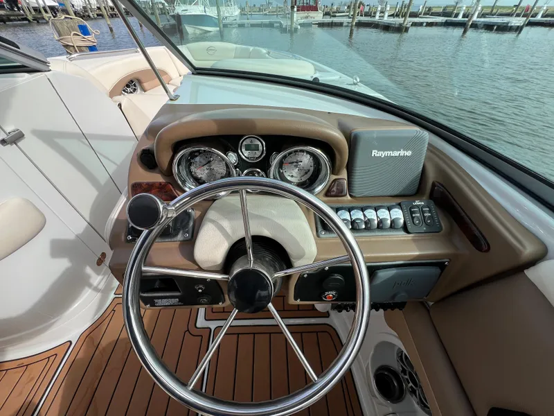 Slide: The Image of 2016 Crownline 270 SS boat dashboard with steering wheel and Raymarine navigation system. - 14