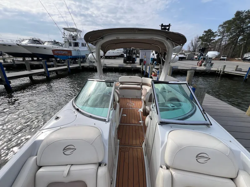 Slide: The Image of 2016 Crownline 270 SS boat docked, featuring spacious seating and sleek design. - 19
