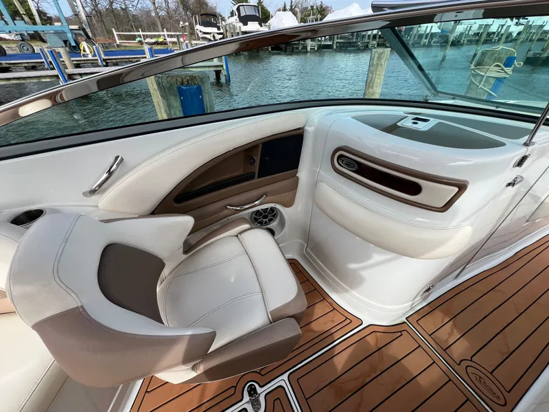Slide: The Image of Interior of a 2016 Crownline 270 SS boat with elegant seating and wood-style flooring. - 21