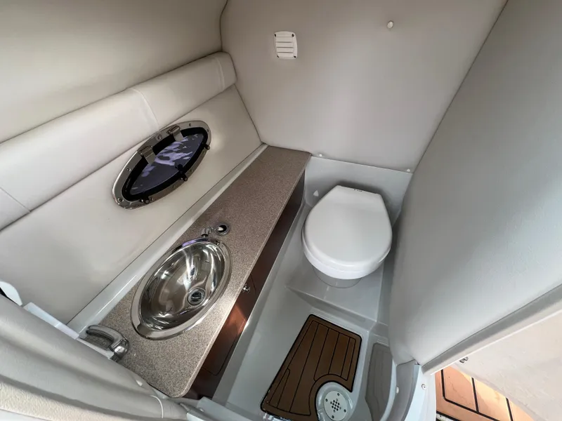 Slide: The Image of Interior of 2016 Crownline 270 SS boat bathroom with sink and toilet. - 22