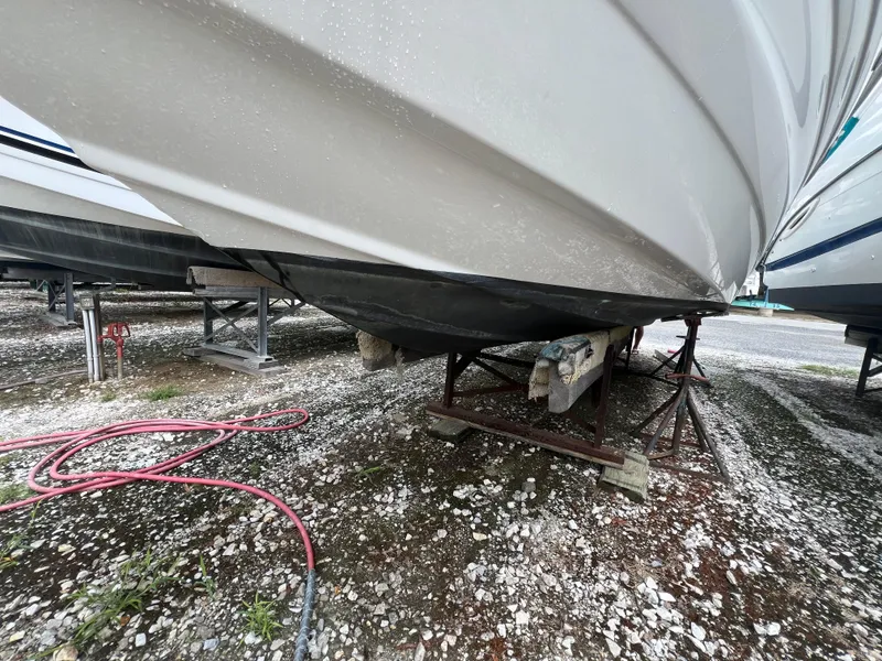 Slide: The Image of 2016 Crownline 270 SS boat on stands, underside view, in storage yard. - 27