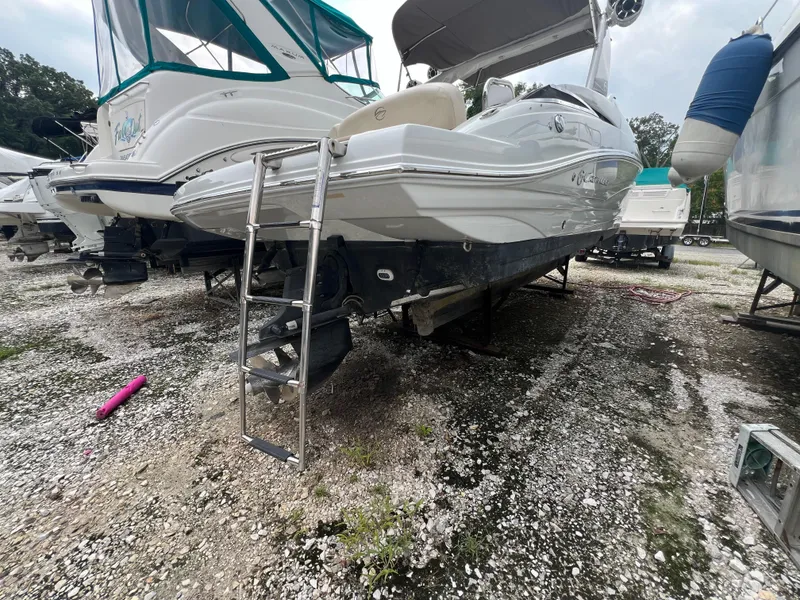 Slide: The Image of 2016 Crownline 270 SS boat on dry dock with ladder, surrounded by other vessels. - 29