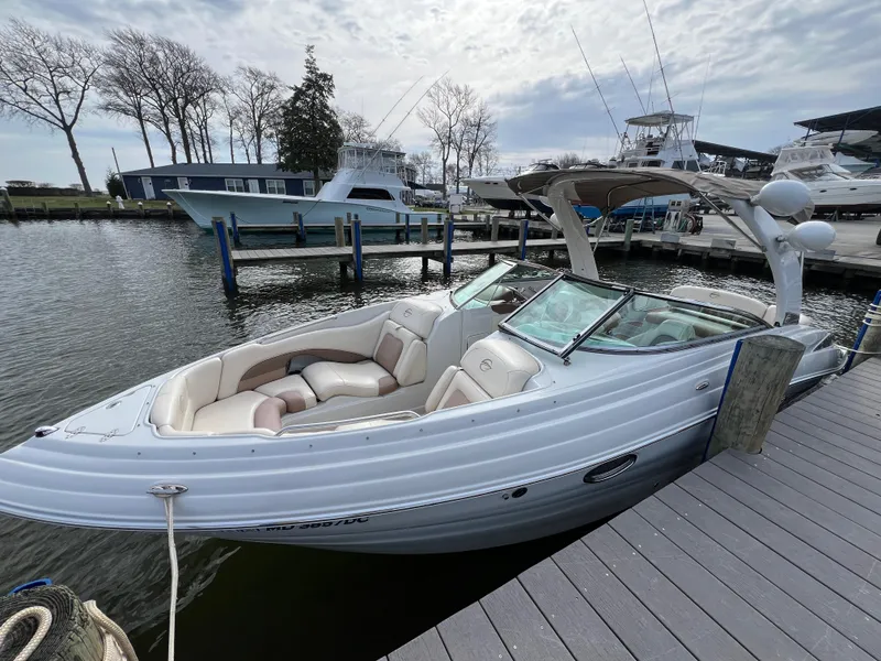 Slide: The Image of 2016 Crownline 270 SS boat docked at marina with overcast sky. - 3