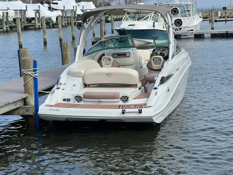 Slide: The Image of 2016 Crownline 270 SS boat docked at marina, featuring sleek design and spacious seating. - 5
