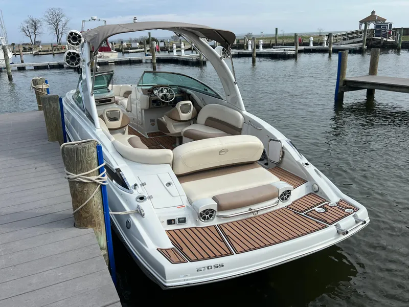 Slide: The Image of 2016 Crownline 270 SS boat docked at a marina, featuring spacious seating and modern design. - 7