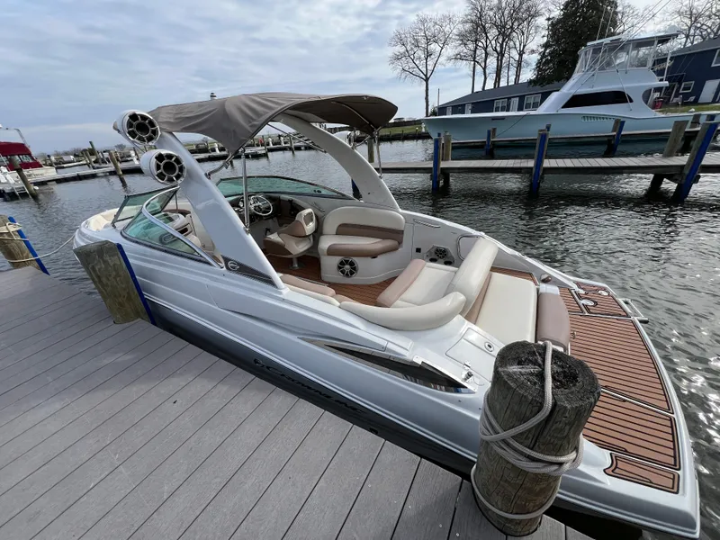 Slide: The Image of 2016 Crownline 270 SS boat docked, featuring sleek design and spacious seating. - 8