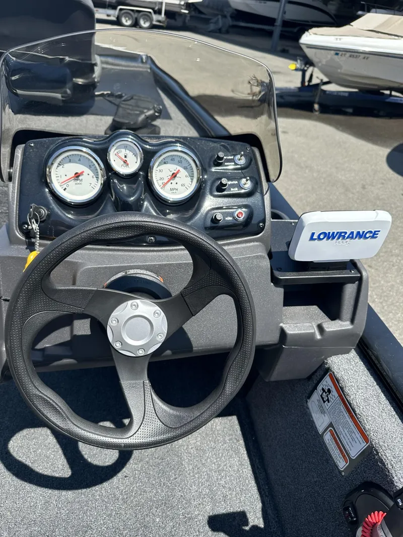 Slide: The Image of 2023 Tracker Pro 170 boat dashboard with steering wheel and Lowrance fishfinder. - 11