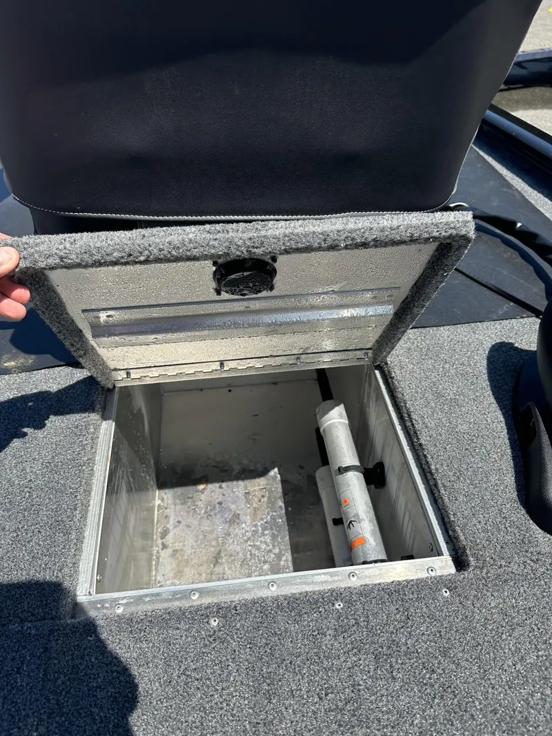 Slide: The Image of 2023 Tracker Pro 170 boat storage compartment with open lid. - 16