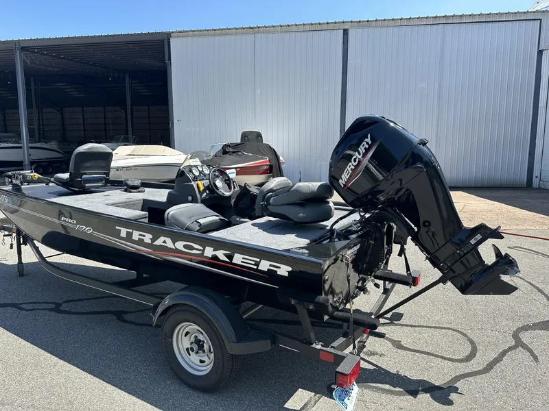 Slide: The Image of 2023 Tracker Pro 170 boat with Mercury outboard motor on trailer. - 2