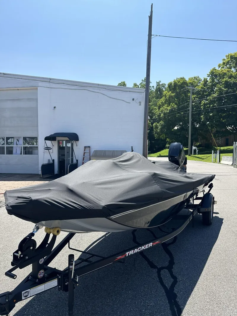 Slide: The Image of 2023 Tracker Pro 170 boat with cover on trailer in parking lot. - 22
