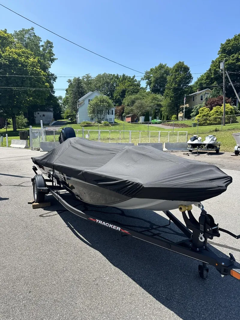 Slide: The Image of 2023 Tracker Pro 170 boat with cover on trailer in residential area. - 23