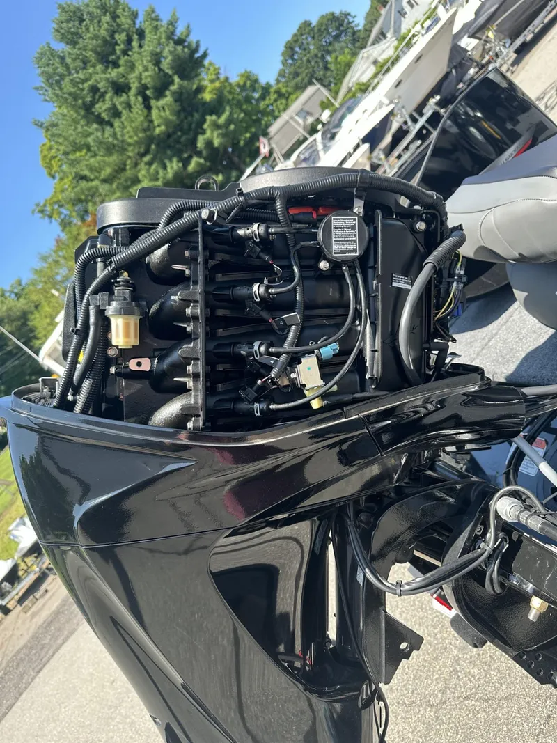 Slide: The Image of 2023 Tracker Pro 170 boat engine with open cover showing internal components. - 25