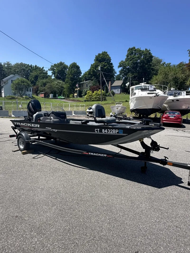 Slide: The Image of 2023 Tracker Pro 170 boat on a trailer in a parking lot. - 6