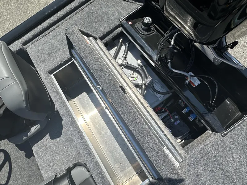 Slide: The Image of 2023 Tracker Pro 170 boat interior showing storage compartments and engine components. - 8