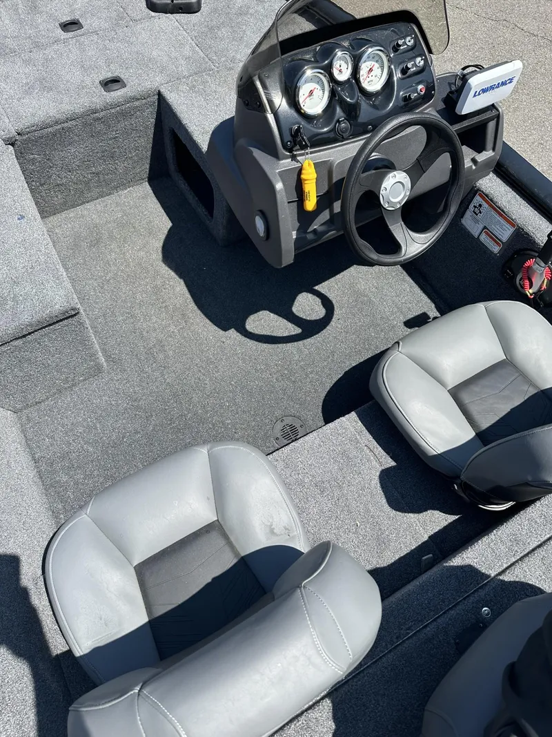 Slide: The Image of 2023 Tracker Pro 170 boat interior with steering console and seating. - 9