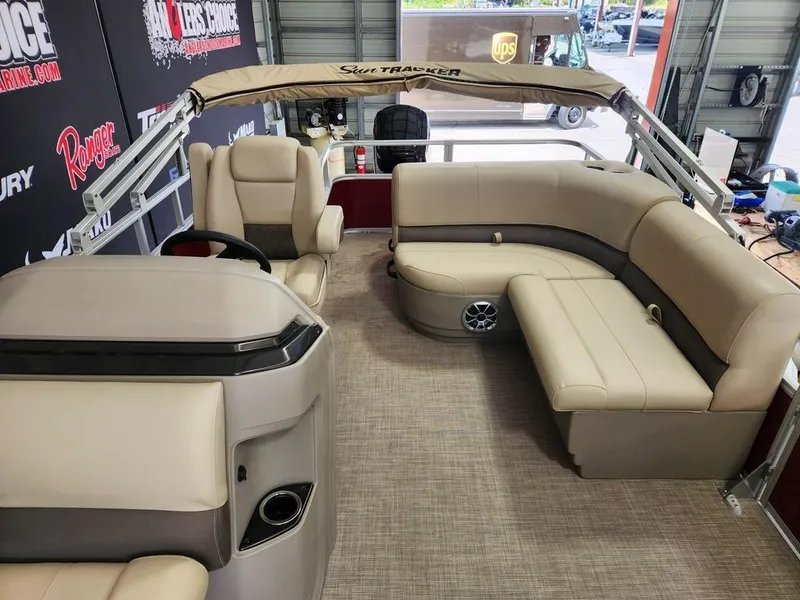 Slide: The Image of 2025 Sun Tracker PARTY BARGE® 18 DLX interior with beige seating and modern design. - 11