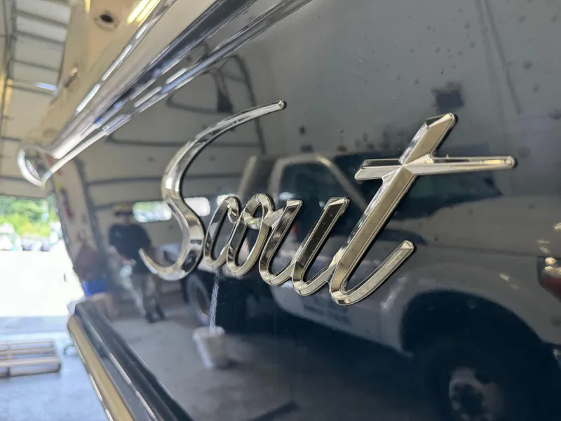 Slide: The Image of Close-up of 2014 Scout 275 Dorado logo on boat in garage. - 11