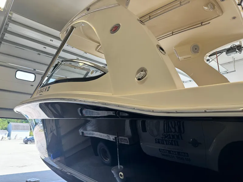 Slide: The Image of 2014 Scout 275 Dorado boat in a garage, side view. - 13