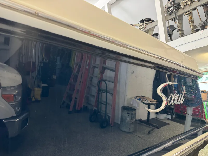 Slide: The Image of 2014 Scout 275 Dorado boat in a garage with equipment. - 14