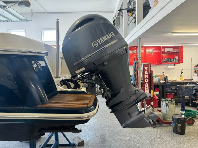 Slide: The Image of 2014 Scout 275 Dorado with Yamaha outboard motor in a workshop. - 15