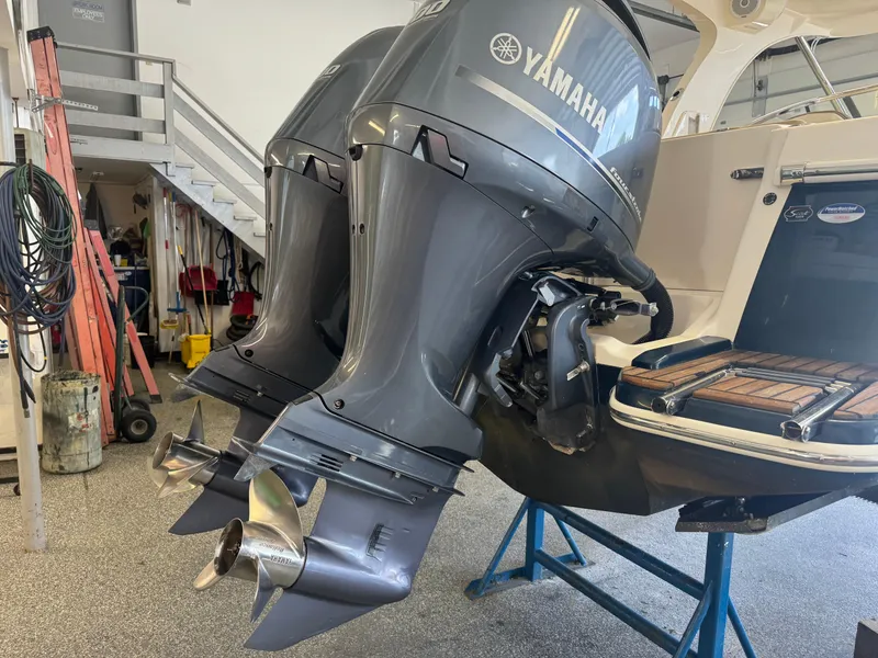 Slide: The Image of 2014 Scout 275 Dorado with twin Yamaha outboard engines in a garage. - 17