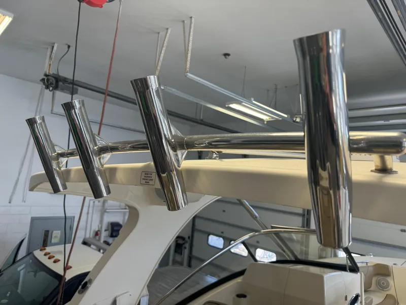 Slide: The Image of 2014 Scout 275 Dorado boat with stainless steel rod holders in a garage. - 19