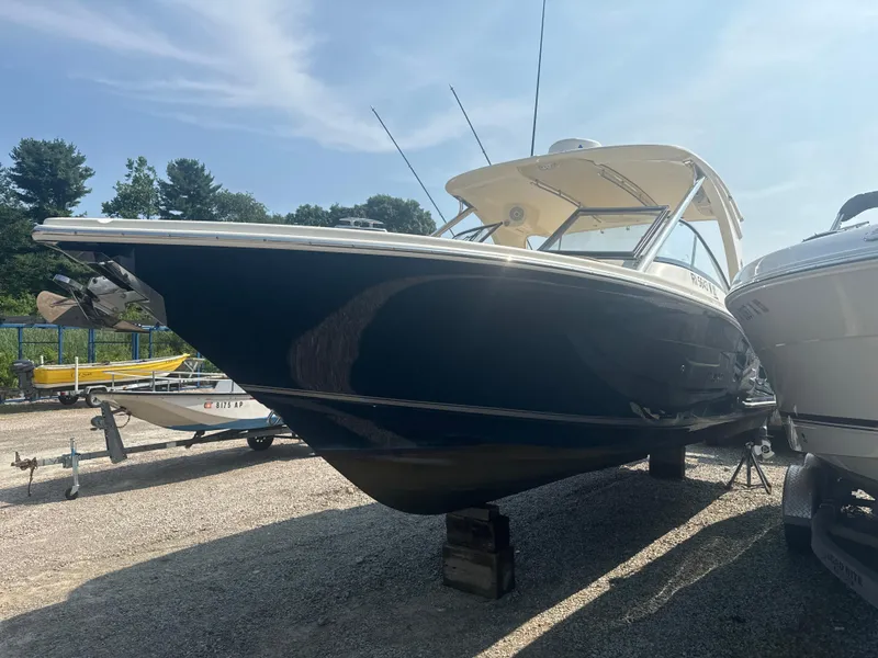 Slide: The Image of 2014 Scout 275 Dorado boat on display in a sunny outdoor setting. - 2