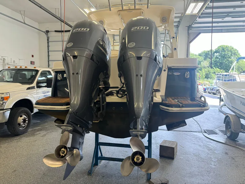 Slide: The Image of 2014 Scout 275 Dorado with twin 200 HP engines in a garage. - 20