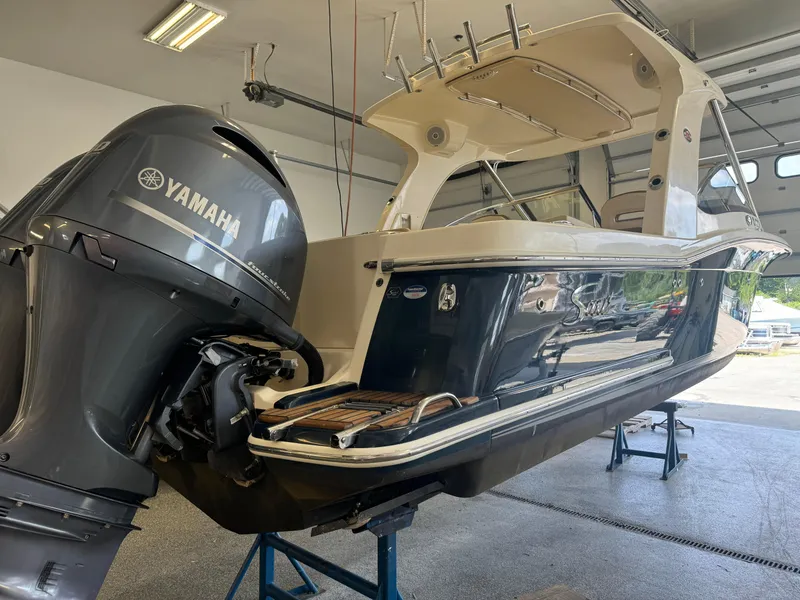 Slide: The Image of 2014 Scout 275 Dorado boat with Yamaha outboard motor in a garage. - 21