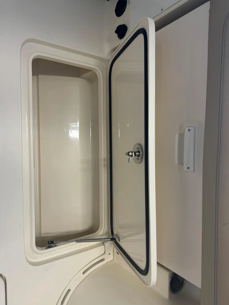 Slide: The Image of 2014 Scout 275 Dorado storage compartment with open hatch. - 22