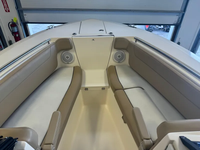 Slide: The Image of 2014 Scout 275 Dorado boat interior with beige seating and built-in speakers. - 23