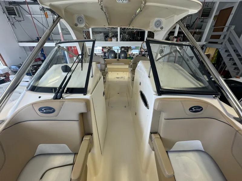 Slide: The Image of 2014 Scout 275 Dorado boat interior with beige seating and dual consoles. - 26