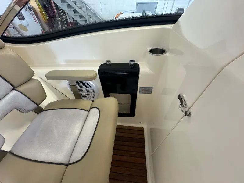 Slide: The Image of Interior of a 2014 Scout 275 Dorado boat with beige seating and wooden flooring. - 28