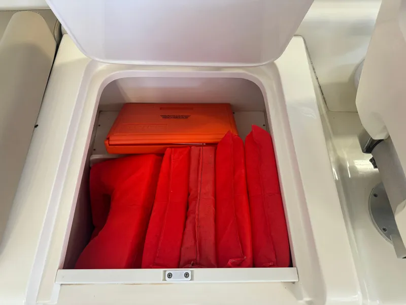 Slide: The Image of Storage compartment with life jackets and safety equipment on a 2014 Scout 275 Dorado boat. - 36