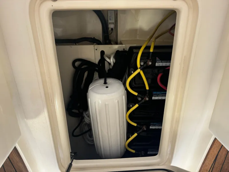 Slide: The Image of 2014 Scout 275 Dorado storage compartment with marine equipment and batteries. - 37