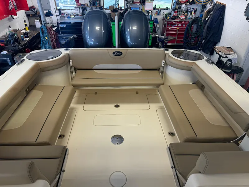 Slide: The Image of 2014 Scout 275 Dorado boat interior with beige seating and twin outboard motors. - 41