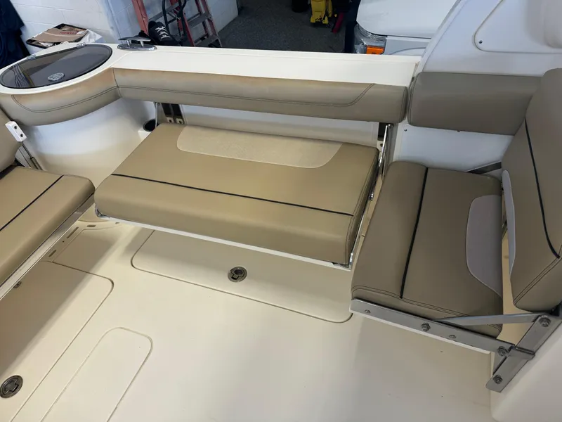 Slide: The Image of 2014 Scout 275 Dorado boat interior seating area with beige cushions. - 42