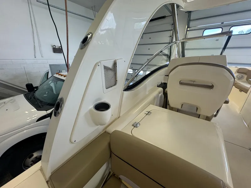 Slide: The Image of Interior of a 2014 Scout 275 Dorado boat in a garage. - 46