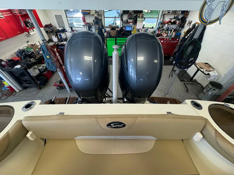 Slide: The Image of 2014 Scout 275 Dorado boat with twin outboard engines in a workshop. - 47